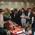 Coffee break - conference participants looking at brochures